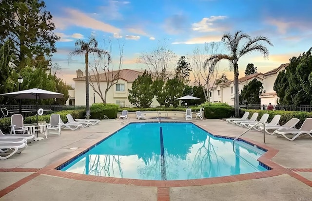 750 Breeze Hill Rd Unit 112, Vista, CA 92081 - pool at dusk featuring a patio area and a community pool