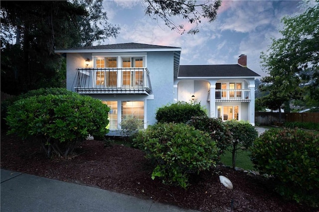 2527 Gibbons St, El Cajon, CA 92020 - view of front of home with a balcony, stucco siding, and a chimney
