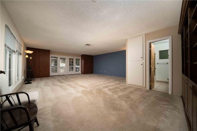 2527 Gibbons St, El Cajon, CA 92020 - unfurnished living room with light colored carpet, healthy amount of natural light, and a textured ceiling