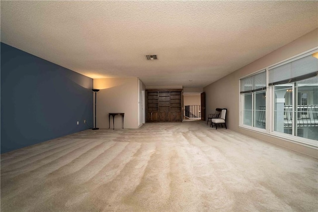 2527 Gibbons St, El Cajon, CA 92020 - unfurnished living room with carpet flooring and a textured ceiling