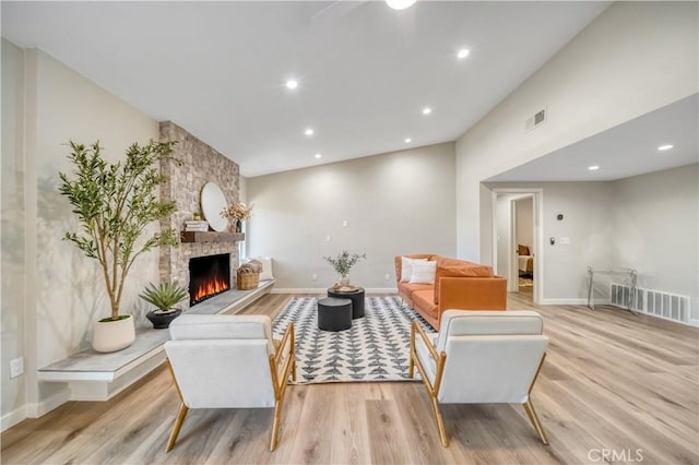 73466 Salt, Cedar, Palm Desert, CA 92260 - living area featuring light wood-style flooring, a stone fireplace, recessed lighting, and a ceiling fan