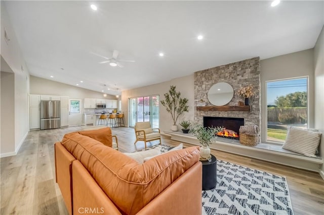 73466 Salt, Cedar, Palm Desert, CA 92260 - living area featuring a ceiling fan, lofted ceiling, a stone fireplace, light wood-style floors, and recessed lighting
