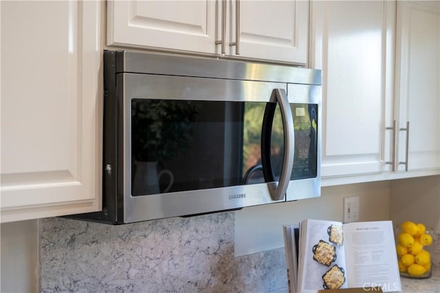 73466 Salt, Cedar, Palm Desert, CA 92260 - kitchen view of stainless steel microwave, white cabinets, and backsplash