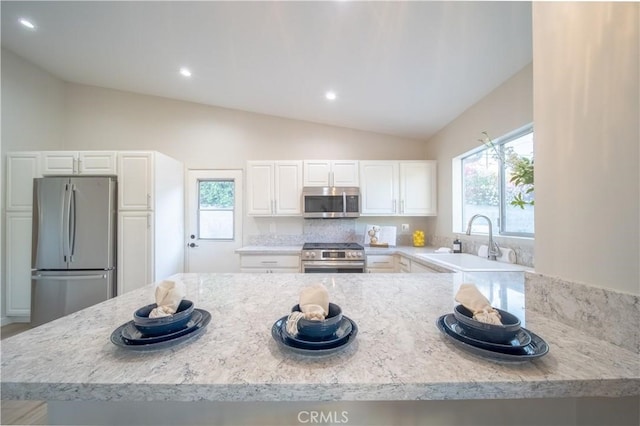 73466 Salt, Cedar, Palm Desert, CA 92260 - kitchen with appliances with stainless steel finishes, lofted ceiling, white cabinetry, recessed lighting, and backsplash