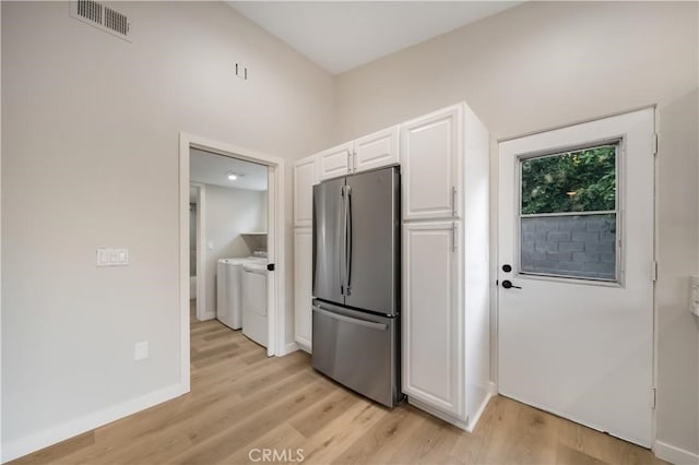73466 Salt, Cedar, Palm Desert, CA 92260 - kitchen with freestanding refrigerator, washer and clothes dryer, light wood-style flooring, and white cabinets