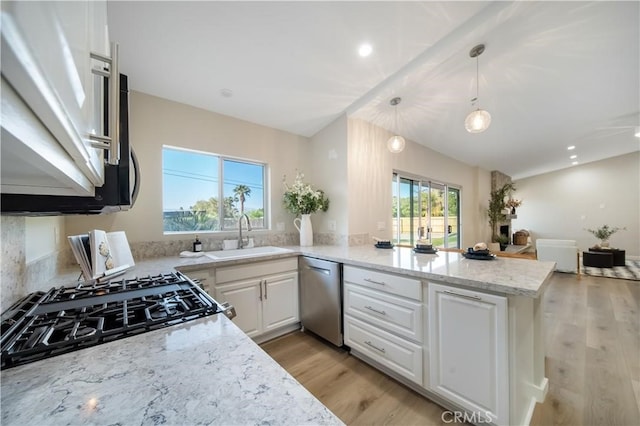 73466 Salt, Cedar, Palm Desert, CA 92260 - kitchen with dishwasher, a peninsula, white cabinets, vaulted ceiling, and light stone counters