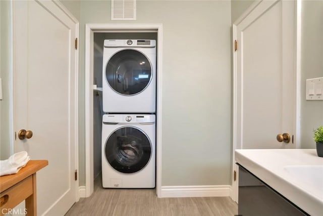 1000 N Chester Ave, Pasadena, CA 91104 - washroom featuring stacked washer and clothes dryer and light wood-type flooring