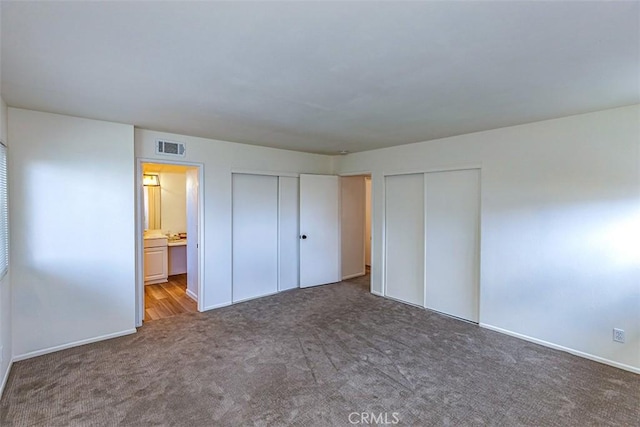 15015 Tacuba Dr, La Mirada, CA 90638 - unfurnished bedroom featuring carpet floors, connected bathroom, and multiple closets