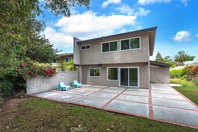 15015 Tacuba Dr, La Mirada, CA 90638 - rear view of house with stucco siding and a patio