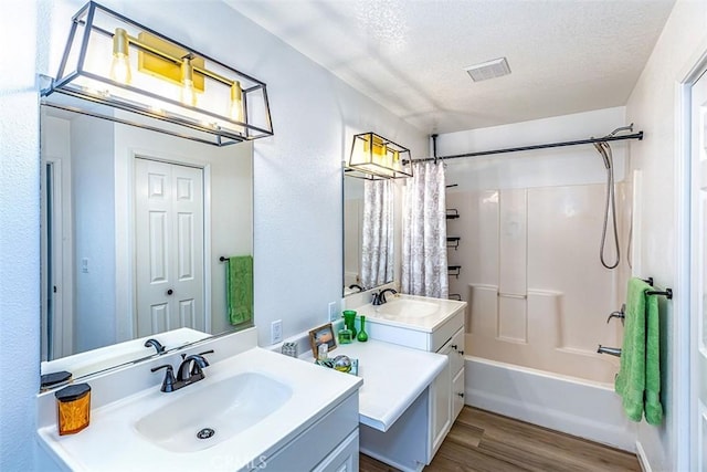 15015 Tacuba Dr, La Mirada, CA 90638 - full bath featuring wood finished floors, vanity, a textured ceiling, and shower / tub combo with curtain