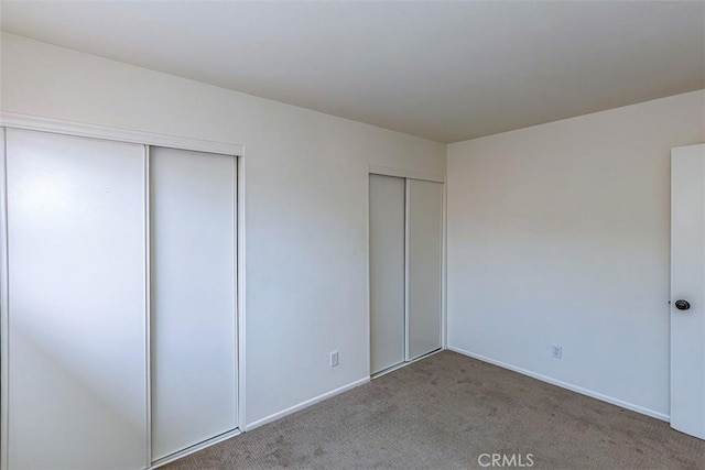15015 Tacuba Dr, La Mirada, CA 90638 - unfurnished bedroom featuring two closets and carpet flooring