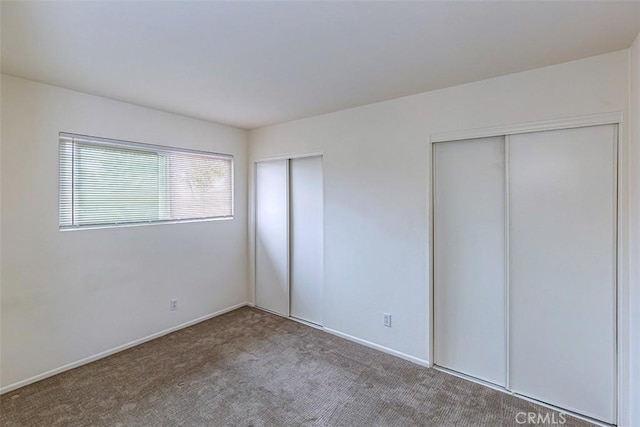 15015 Tacuba Dr, La Mirada, CA 90638 - unfurnished bedroom with two closets and carpet floors