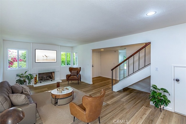 15015 Tacuba Dr, La Mirada, CA 90638 - living room with a fireplace, light wood finished floors, stairway, and recessed lighting