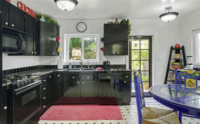 4260 Mcconnell Blvd, Los Angeles, CA 90066 - kitchen with black appliances, light flooring, dark cabinets, and tile counters