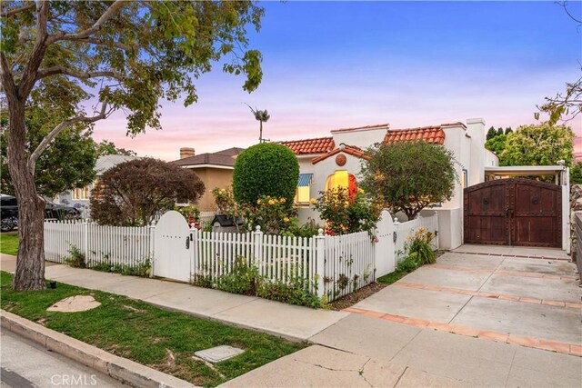 4260 Mcconnell Blvd, Los Angeles, CA 90066 - view of front of property with a gate, a tile roof, stucco siding, a fenced front yard, and concrete driveway