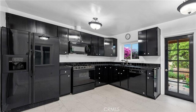 4260 Mcconnell Blvd, Los Angeles, CA 90066 - kitchen with black appliances, dark cabinetry, and dark countertops