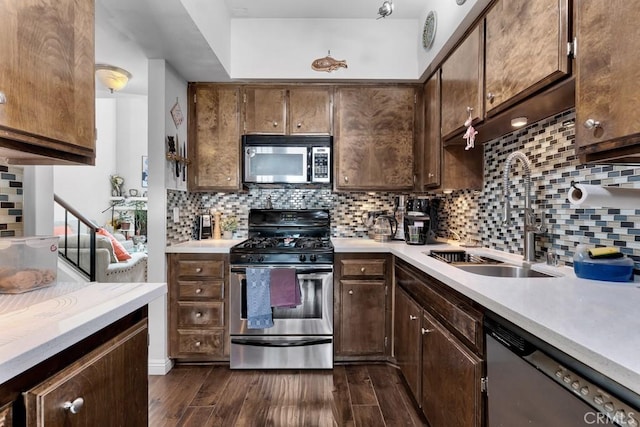 6323 Reseda Blvd Unit 13, Tarzana, CA 91335 - kitchen featuring appliances with stainless steel finishes, light countertops, dark wood finished floors, and decorative backsplash