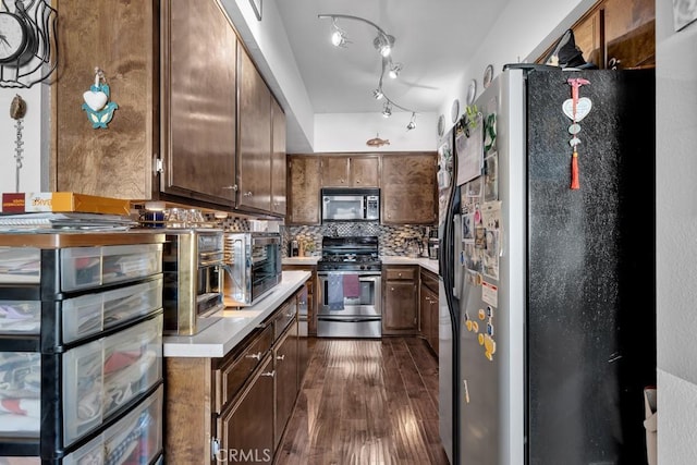 6323 Reseda Blvd Unit 13, Tarzana, CA 91335 - kitchen featuring stainless steel appliances, light countertops, decorative backsplash, and dark wood-style floors