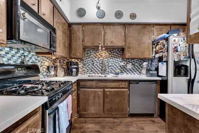 6323 Reseda Blvd Unit 13, Tarzana, CA 91335 - kitchen featuring appliances with stainless steel finishes, light countertops, backsplash, and dark wood finished floors
