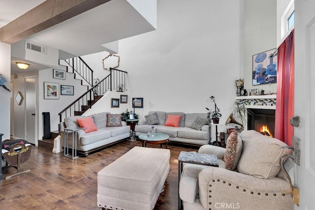 6323 Reseda Blvd Unit 13, Tarzana, CA 91335 - living area with stairway, a glass covered fireplace, wood finished floors, a towering ceiling, and beamed ceiling