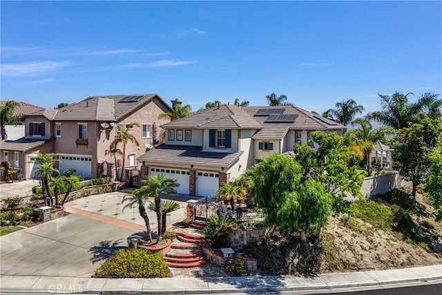 1411 W Boros Ct, La Habra, CA 90631 - view of front of home with an attached garage, driveway, roof mounted solar panels, a tile roof, and stucco siding