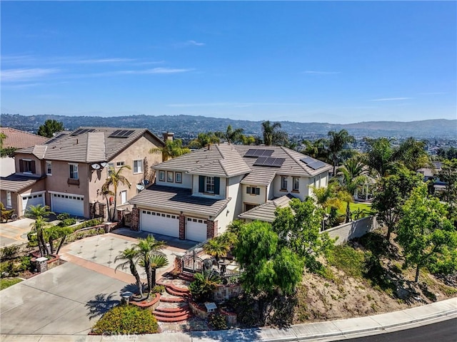 1411 W Boros Ct, La Habra, CA 90631 - view of front of house with an attached garage, a tile roof, driveway, stucco siding, and a residential view