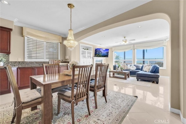 1411 W Boros Ct, La Habra, CA 90631 - dining area with crown molding, arched walkways, a chandelier, light tile patterned floors, and a ceiling fan