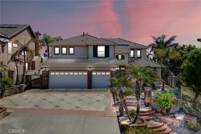 1411 W Boros Ct, La Habra, CA 90631 - view of front of property with a tile roof, driveway, an attached garage, solar panels, and stucco siding