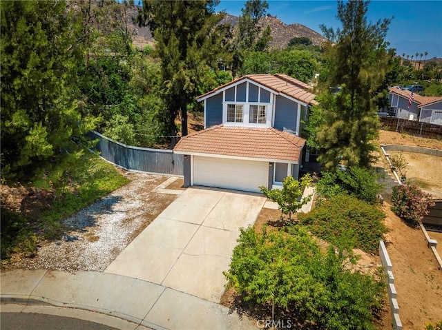 11359 Dole Ct, Riverside, CA 92505 - view of front of house with a tile roof, driveway, a garage, and stucco siding