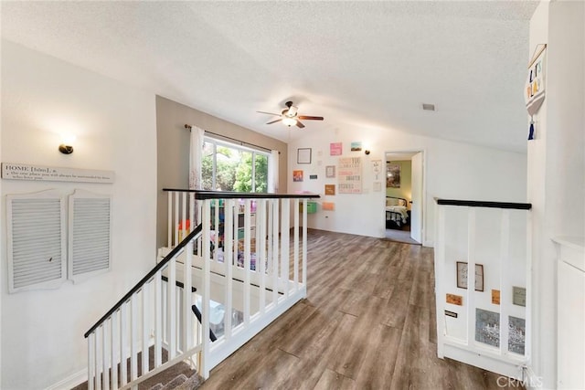 11359 Dole Ct, Riverside, CA 92505 - hallway featuring an upstairs landing, wood finished floors, a textured ceiling, and vaulted ceiling