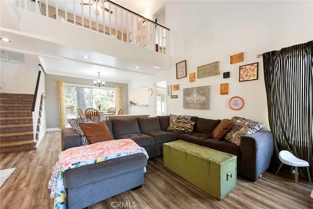 11359 Dole Ct, Riverside, CA 92505 - living area featuring stairs, wood finished floors, a chandelier, and a towering ceiling