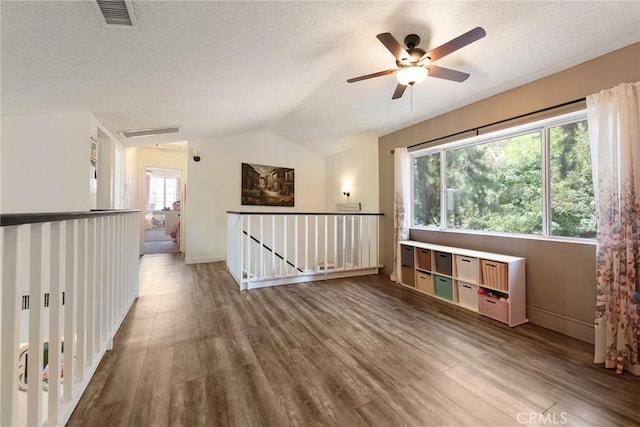 11359 Dole Ct, Riverside, CA 92505 - unfurnished room with vaulted ceiling, wood finished floors, a ceiling fan, and a textured ceiling