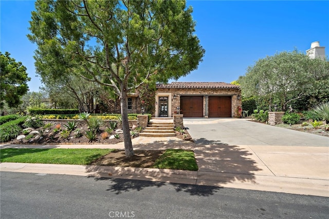 15 Sarteano Dr, Newport Coast, CA 92657 - view of front of home with driveway, a garage, a tile roof, and stone siding
