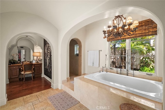 15 Sarteano Dr, Newport Coast, CA 92657 - full bath with a garden tub, a chandelier, vanity, and stone tile flooring