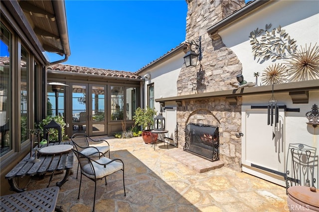 15 Sarteano Dr, Newport Coast, CA 92657 - view of patio with an outdoor stone fireplace and french doors