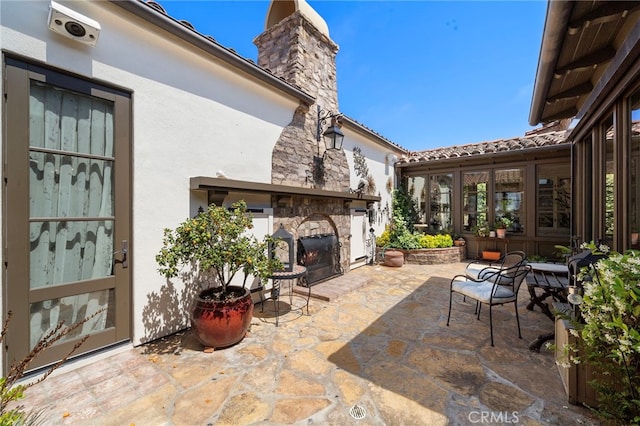 15 Sarteano Dr, Newport Coast, CA 92657 - view of patio / terrace with an outdoor stone fireplace