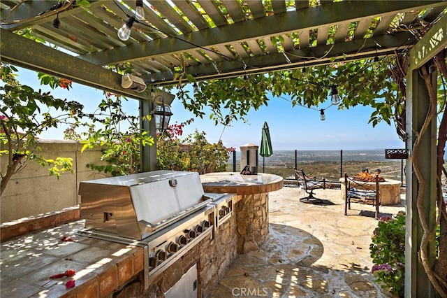 15 Sarteano Dr, Newport Coast, CA 92657 - view of patio with an outdoor fire pit, exterior kitchen, and a pergola