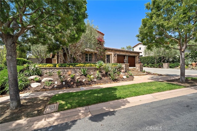 15 Sarteano Dr, Newport Coast, CA 92657 - view of front of house featuring a tiled roof, concrete driveway, an attached garage, stone siding, and stucco siding