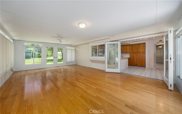 1144 Jasmine St, Redlands, CA 92374 - unfurnished living room with french doors, light wood-type flooring, and ceiling fan