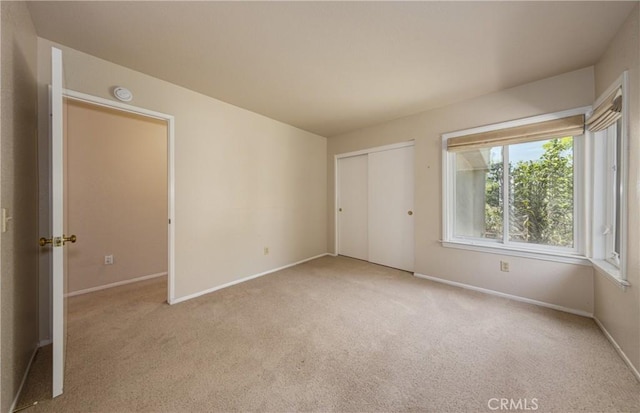 1144 Jasmine St, Redlands, CA 92374 - unfurnished bedroom featuring light carpet and a closet