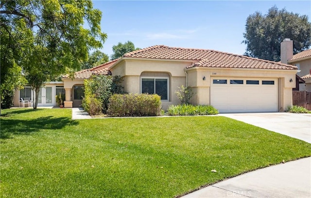 1144 Jasmine St, Redlands, CA 92374 - mediterranean / spanish-style house featuring concrete driveway, a garage, stucco siding, and a front lawn