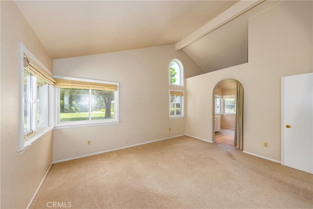 1144 Jasmine St, Redlands, CA 92374 - empty room featuring arched walkways, light colored carpet, beam ceiling, and high vaulted ceiling