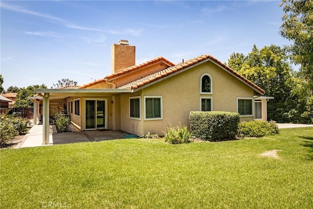 1144 Jasmine St, Redlands, CA 92374 - back of house featuring a chimney, stucco siding, a patio area, and a tile roof