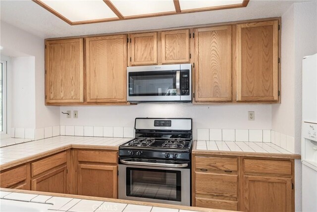 1144 Jasmine St, Redlands, CA 92374 - kitchen featuring appliances with stainless steel finishes and tile counters