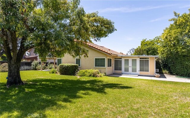 1144 Jasmine St, Redlands, CA 92374 - back of house featuring french doors, stucco siding, and a lawn