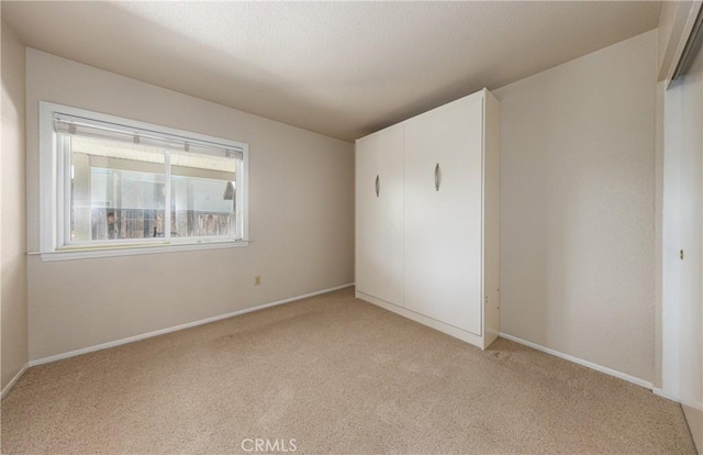 1144 Jasmine St, Redlands, CA 92374 - unfurnished bedroom with light carpet and a closet