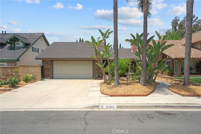 21845 Tumbleweed Cir, Lake Forest, CA 92630 - view of front of home with concrete driveway and an attached garage
