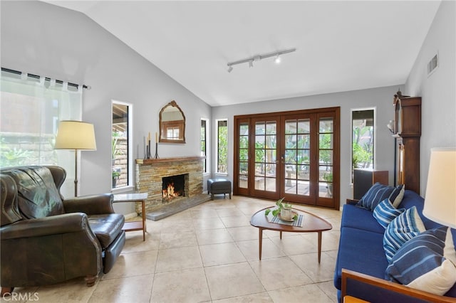 21845 Tumbleweed Cir, Lake Forest, CA 92630 - tiled living room with lofted ceiling, french doors, a fireplace, and track lighting