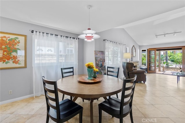 21845 Tumbleweed Cir, Lake Forest, CA 92630 - dining area featuring light tile patterned floors, vaulted ceiling, and rail lighting