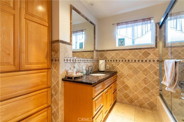 13837 Sylvan St, Valley Glen, CA 91401 - bathroom with tile walls, vanity, bath / shower combo with glass door, a wainscoted wall, and tile patterned floors